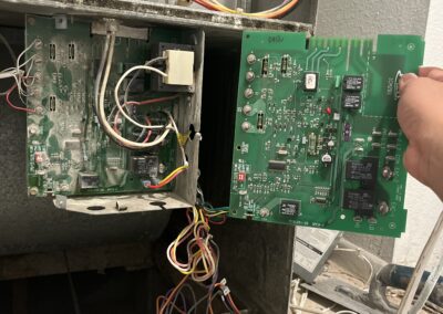 A person troubleshooting or servicing an hvac control board.